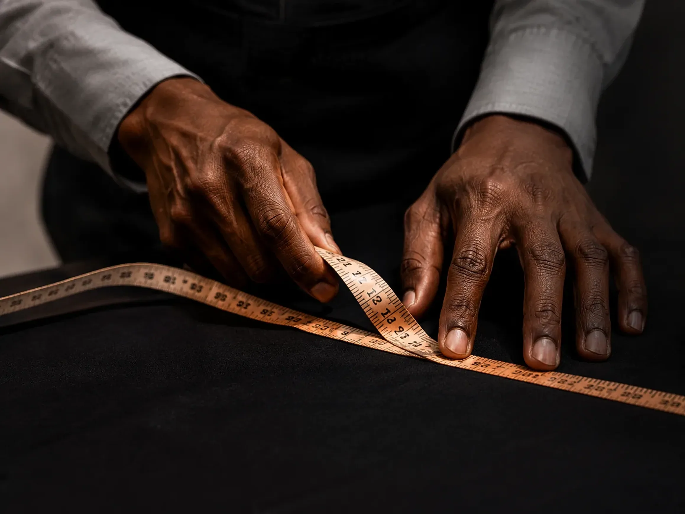 Tailor measuring black fabric